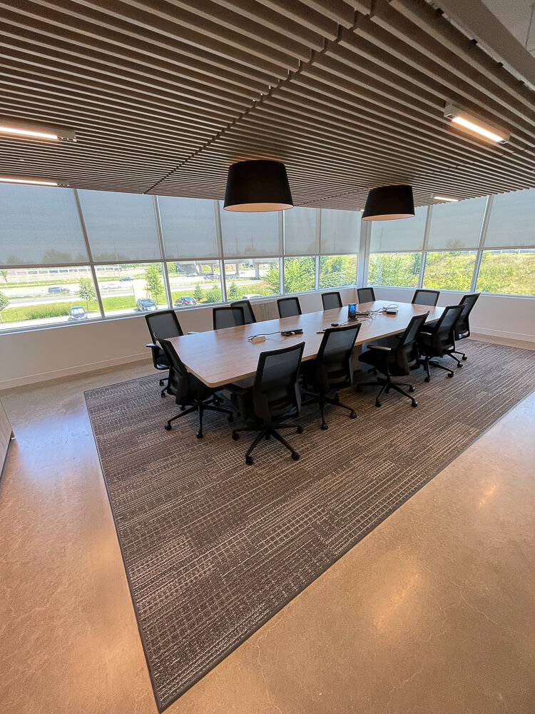 modern and chic open concept board room with wood ceilings and floors.