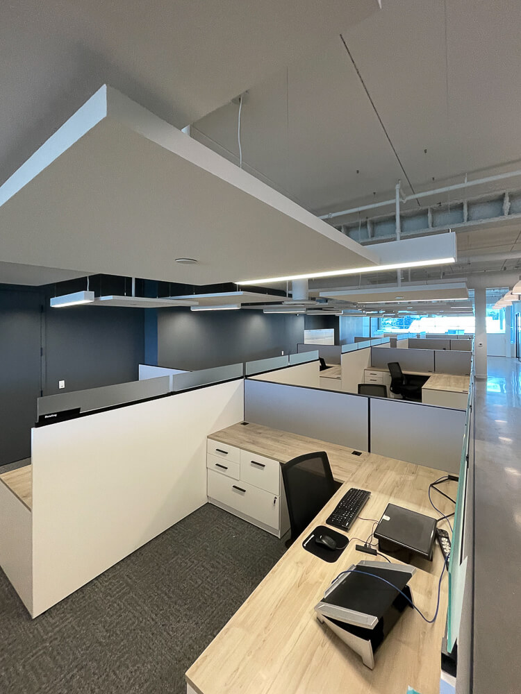 Cool chic open concept office with spotless teak wood desks.