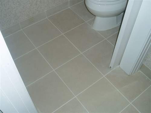 Janitorial Services – Clean Tile Restroom Floor in Hamilton Office Building Disinfected tile floor in office restroom maintained by janitorial crew at iCleaners in Hamilton L8H area