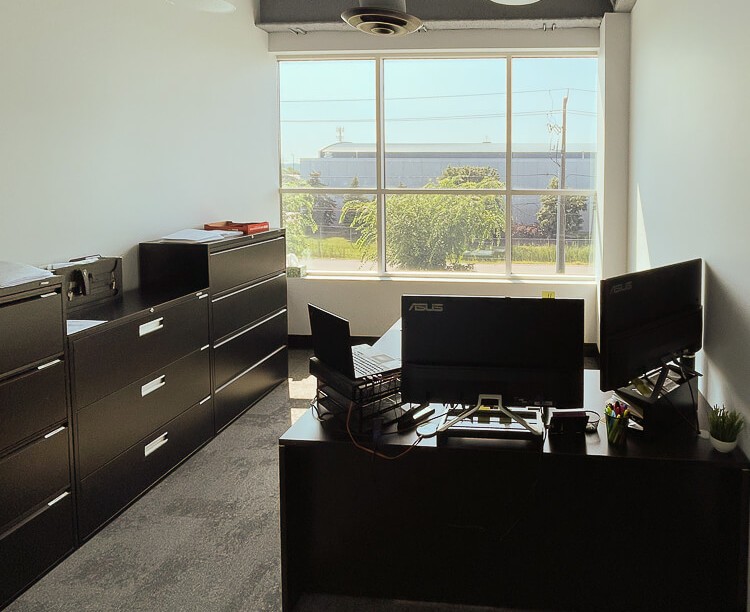 Disinfected modern office with large windows and clean carpeted floor in Hamilton’s L8L business district
